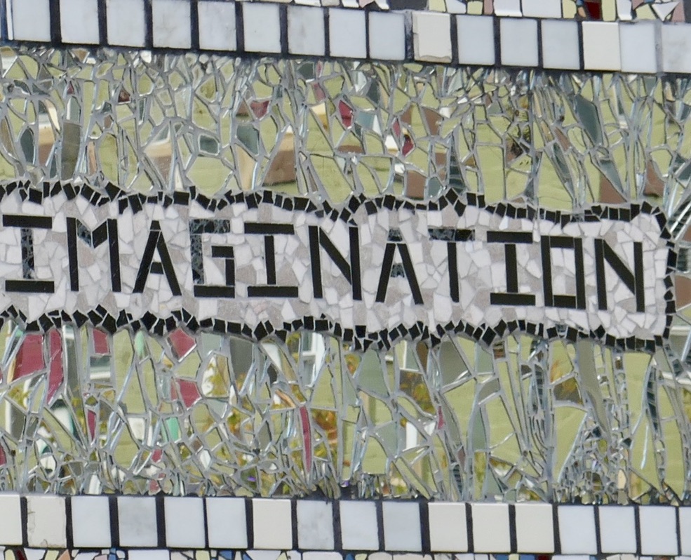art piece- the word imagination in tile