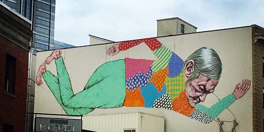 An outdoor art piece on the side of a building.